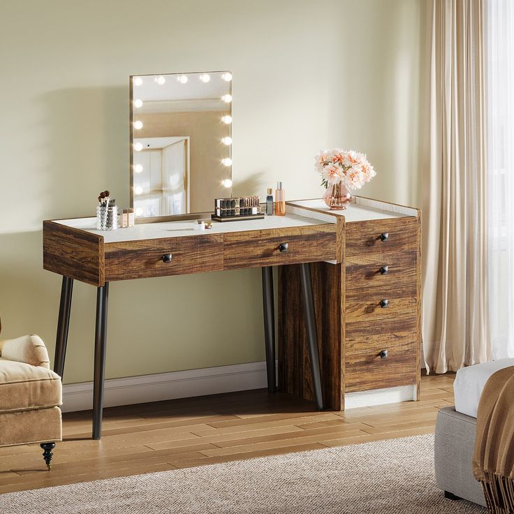 a dressing table with a mirror and lights on it in a room next to a couch