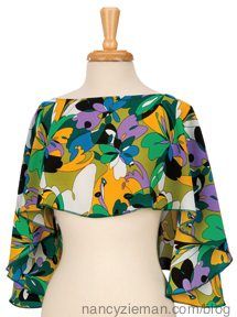 a mannequin wearing a colorful top with flowers on the front and back,