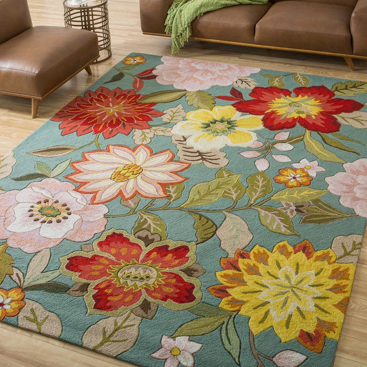 a living room filled with furniture and flowers on the rug