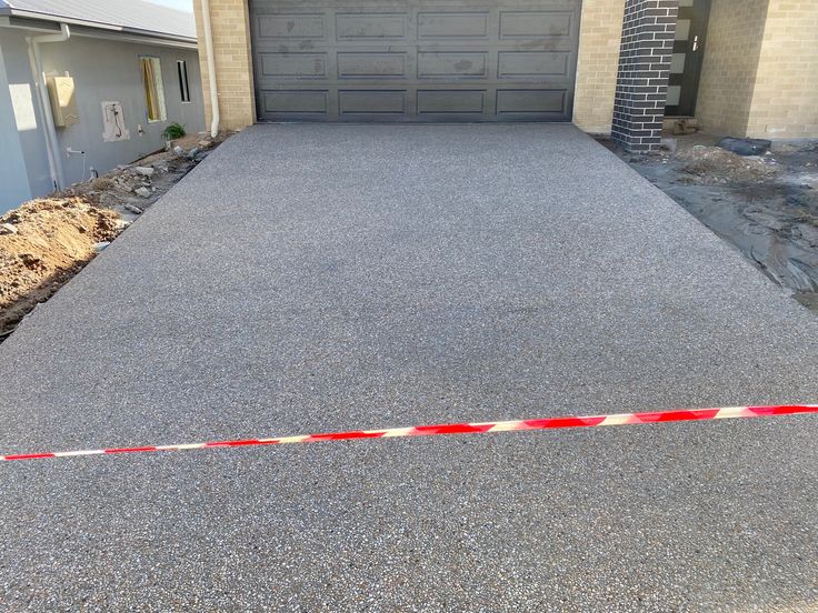 An image of driveway Exposed Aggregate Concrete, Aggregate Concrete, Clean Concrete, Exposed Aggregate, Concrete Resurfacing, Concrete Finishes, Driveway Design, Concrete Contractor, Concrete Driveways