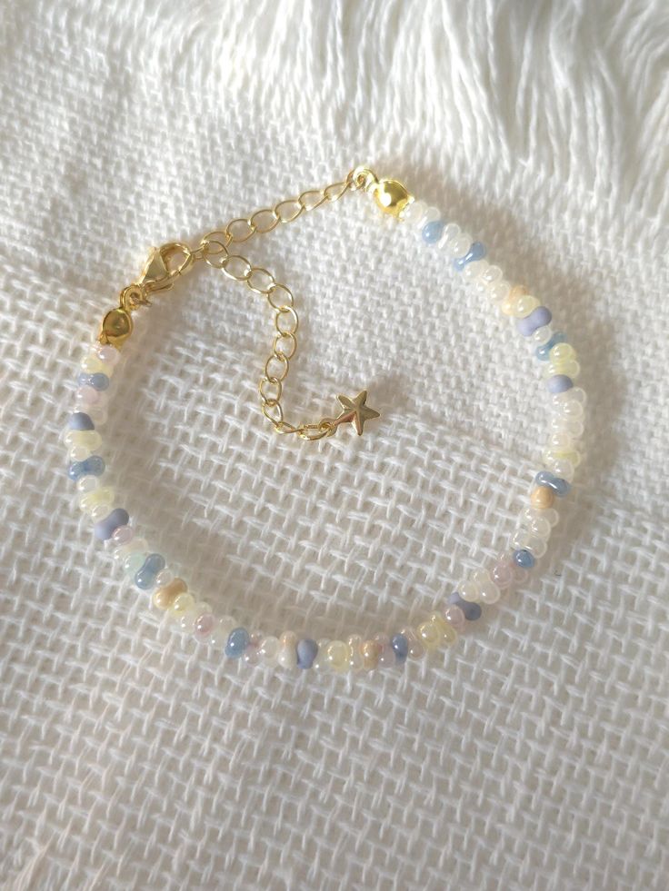 FOR OTHER DAINTY BEADED BRACELETS: https://www.etsy.com/ca/shop/ArtiChouXCanada?ref=seller-platform-mcnav§ion_id=46088511 Bracelet Length: 13-18cm (5.1-7 inches) with a 14k gold filled extender. This bracelet features an array of summer themed pastel colors: blue, white, cream, and light purple Japanese seed beads.  Thread may be visible since it is a handmade product   SIZING  Wrap a soft measuring tape snugly around the widest part of your wrist. Add 1.27cm (0.5in) to that measurement to determine the right bracelet size.  MATERIALS  - Japanese MGB glass seed beads(2x4mm) - 14K gold filled extender  CARE INSTRUCTIONS   To maintain its radiance, gently clean the bracelet with a soft cloth and store it in a jewelry box or pouch when not in use.   SHIPPING INFORMATION  Canada: Standard Ship Adjustable Pastel Beaded Bracelets, Beaded Bracelets Seed Beads, Small Glass Bead Bracelet Ideas, Matching Seed Bead Bracelets, Pastel Beaded Bracelets Gift, Pastel Beaded Bracelets As Gift, Pastel Beaded Bracelets For Gift, Adjustable Pastel Beaded Jewelry, Light Blue Beaded Bracelets As Gift