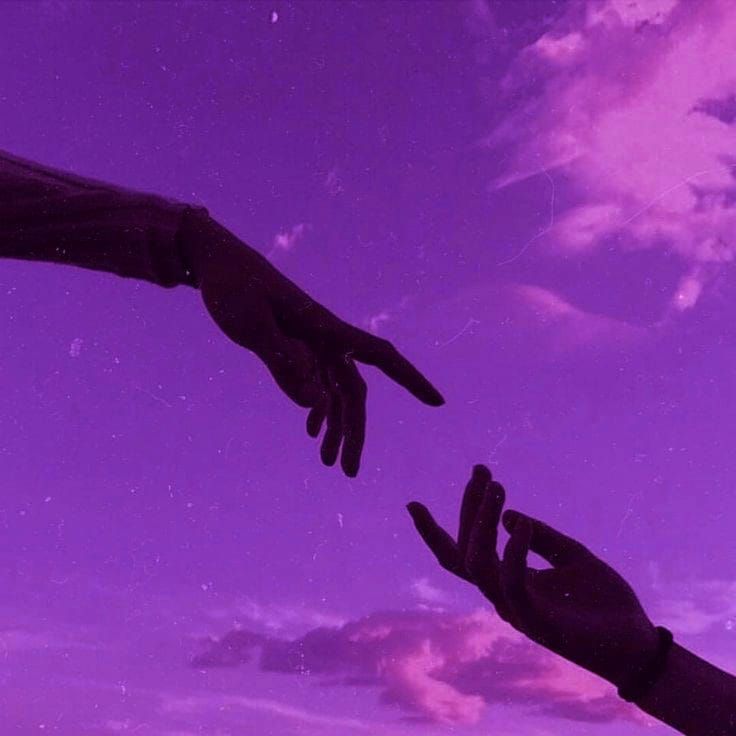 two hands reaching towards each other in front of a purple and blue sky with clouds