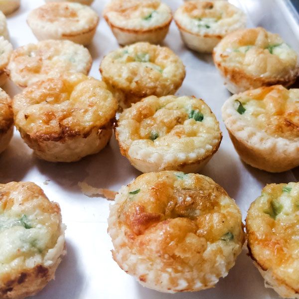 several small muffins are sitting on a baking sheet and ready to be eaten