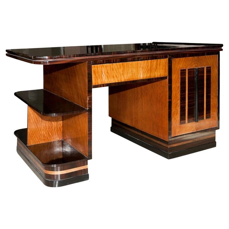 an art deco desk with black marble top and wooden trimmings on the sides