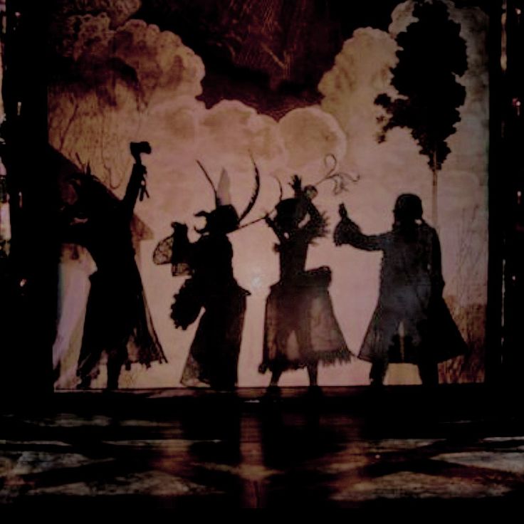 the silhouettes of three people are dancing on stage