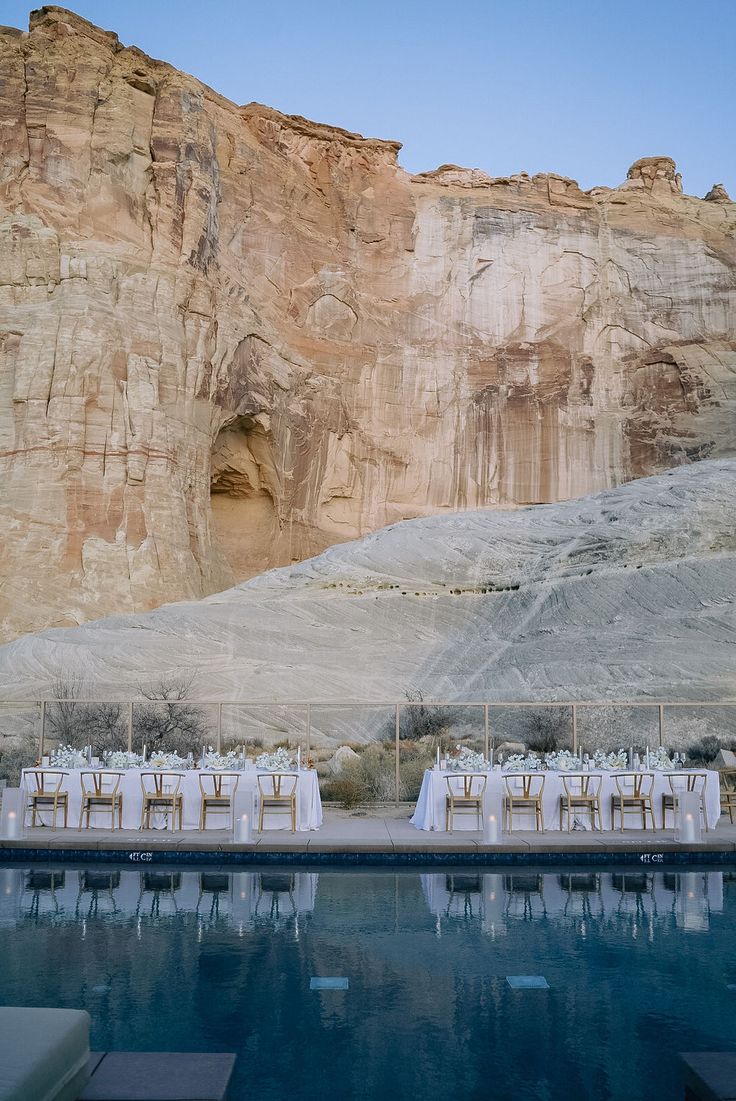 an outdoor wedding set up in front of a mountain