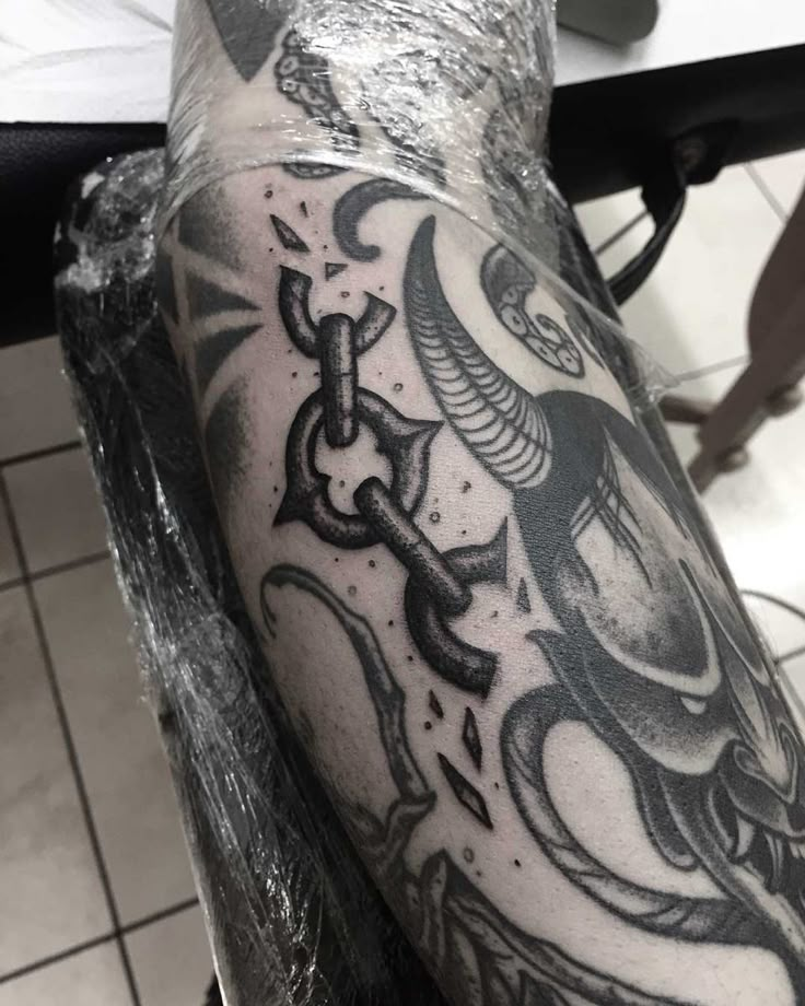 a man's arm with tattoos on it