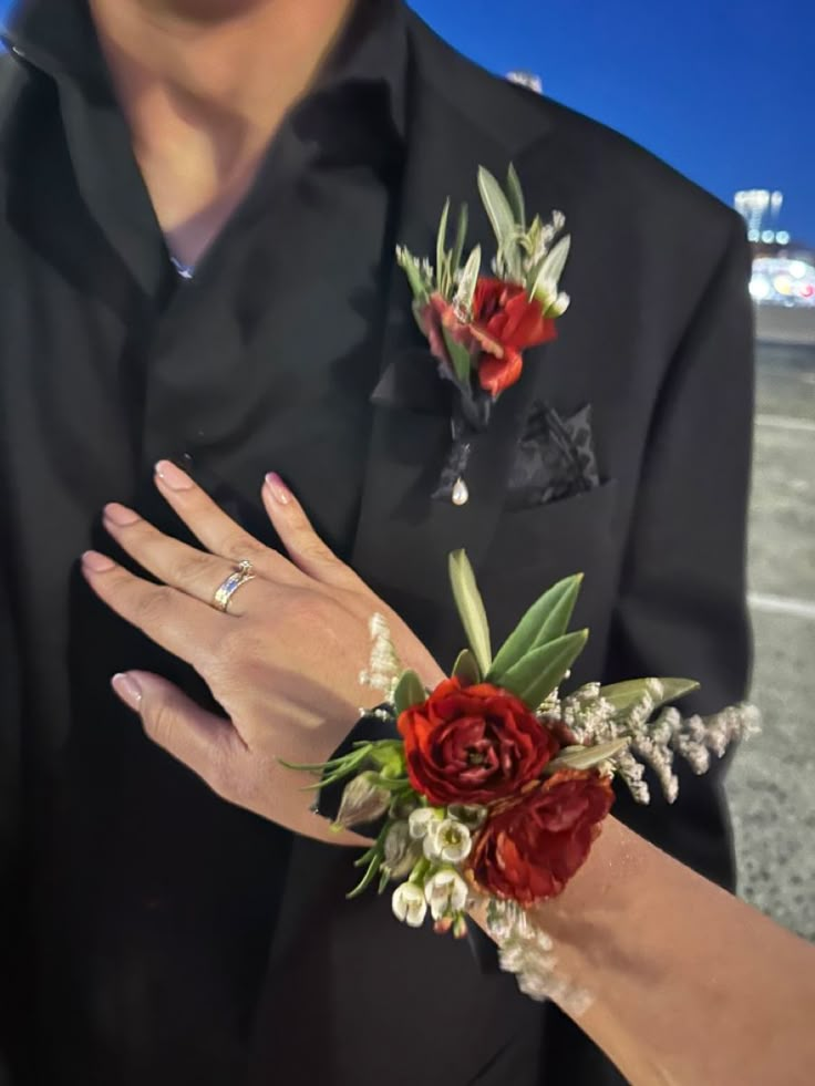 Corsages And Boutonnieres Homecoming, Prom Flowers Corsage Red, Corsage And Boutonniere Black Dress, Corsage Ideas For Black Dress, Red Prom Dress Corsage, Black And Red Boutonniere, Black Suit Red Boutonniere, Corsage For Red Dress Prom, Red Dress Corsage