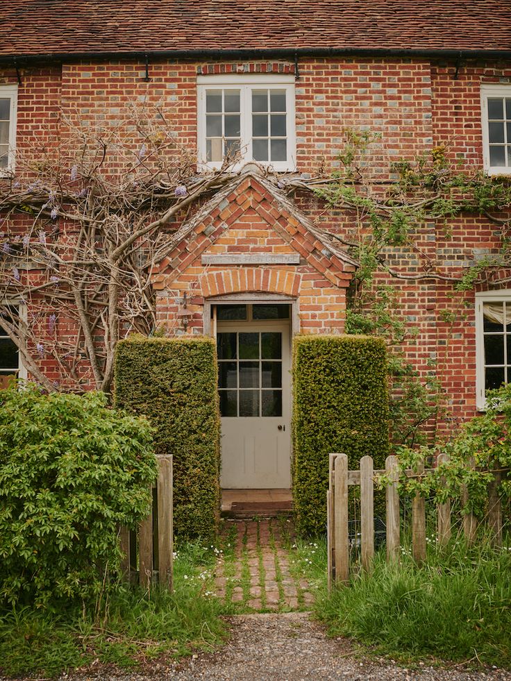 an old brick house with ivy growing on it's sides