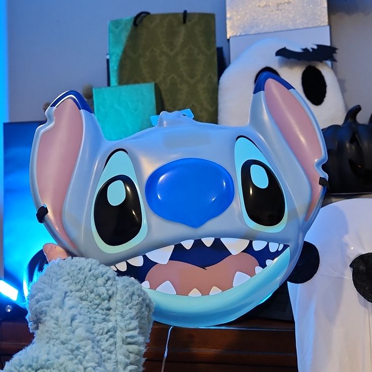 a stuffed animal with big teeth next to other stuffed animals