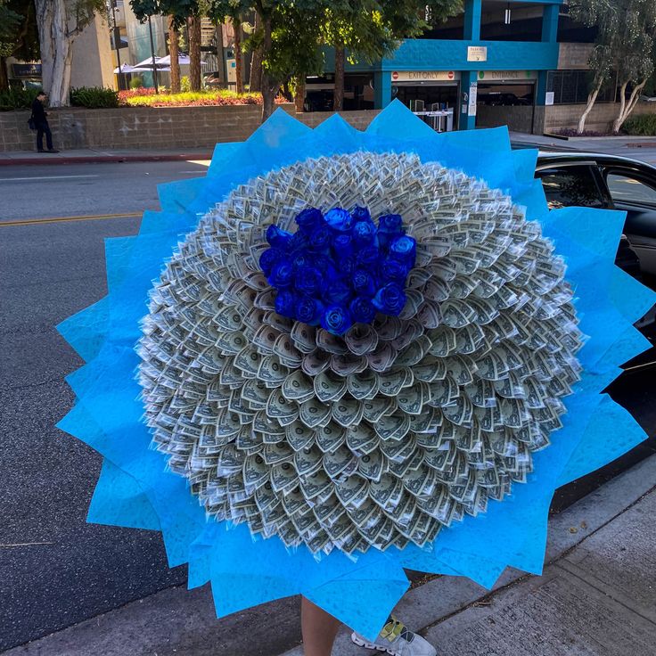 a blue and white sculpture on the sidewalk