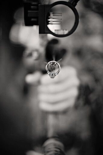 a black and white photo of a person holding a cell phone up to the camera