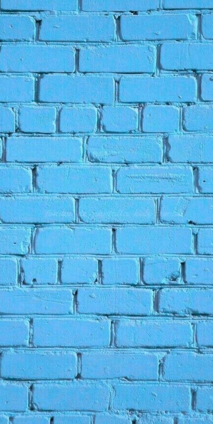 a blue brick wall that is painted bright blue