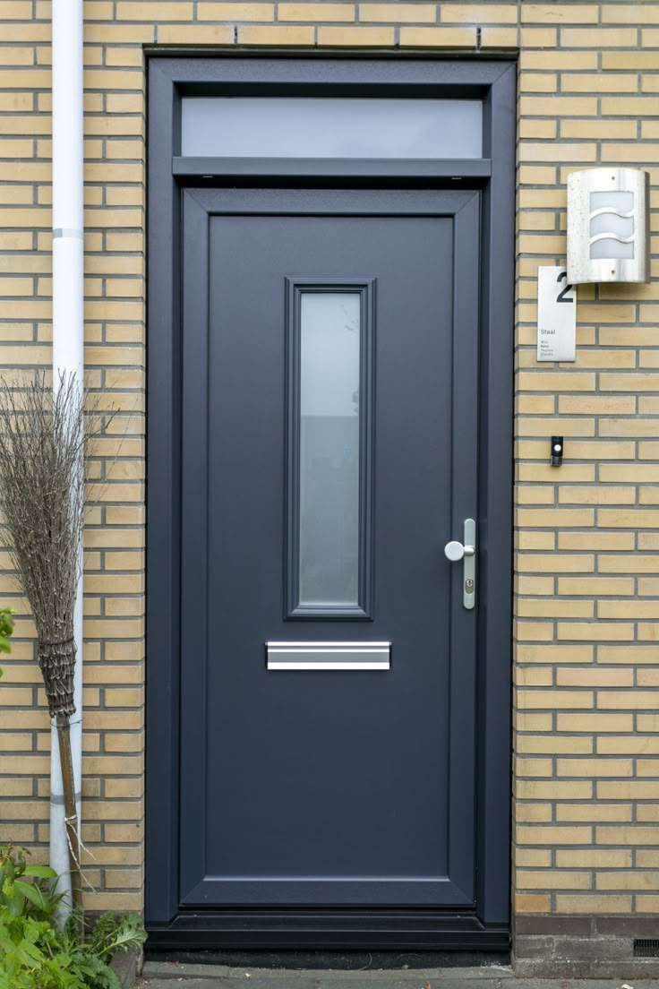 a blue front door on a brick building