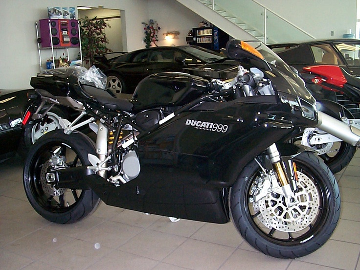 a black motorcycle is parked in a showroom