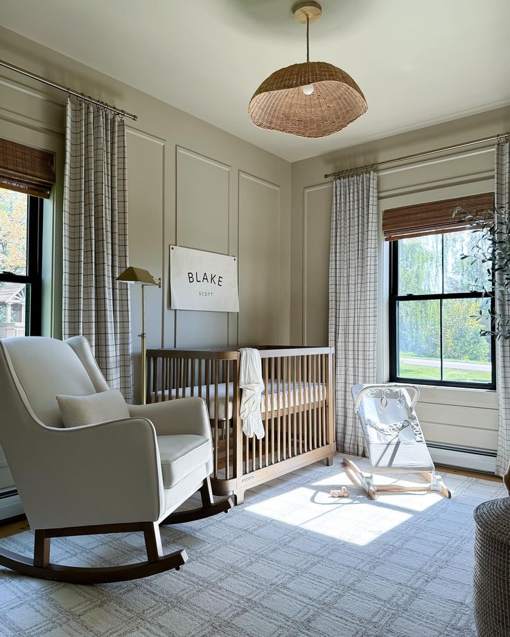 a baby's room with a rocking chair, crib and large windows in it