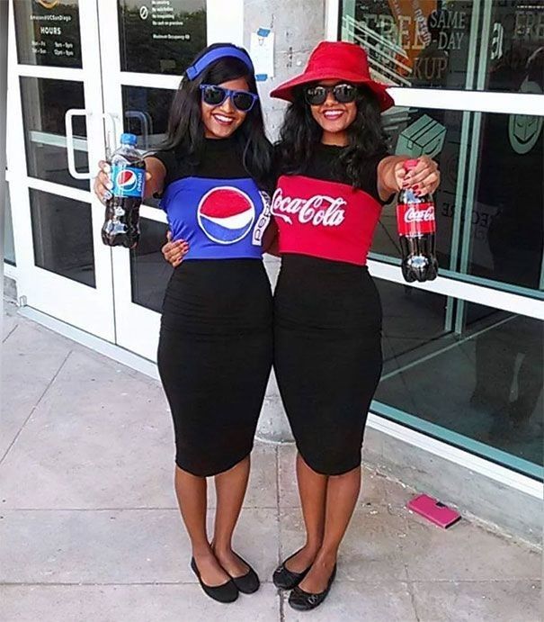 two women standing next to each other in front of a building holding soda cans and pepsi bottles