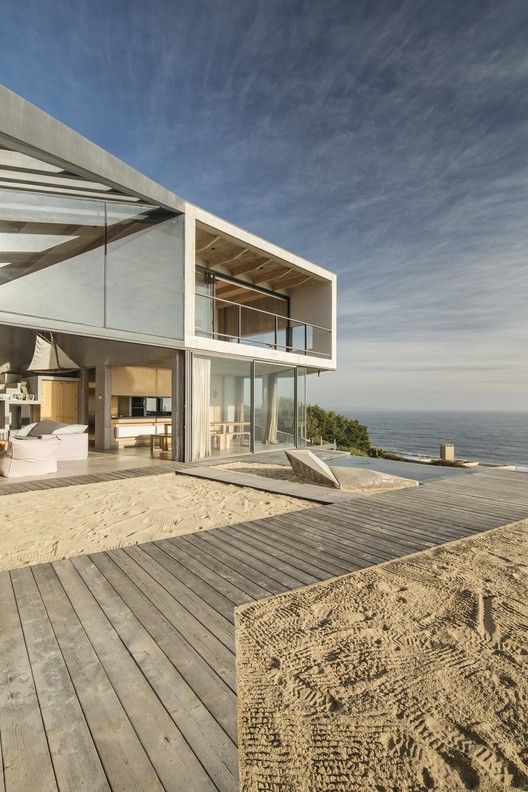 a house on the beach with an ocean view