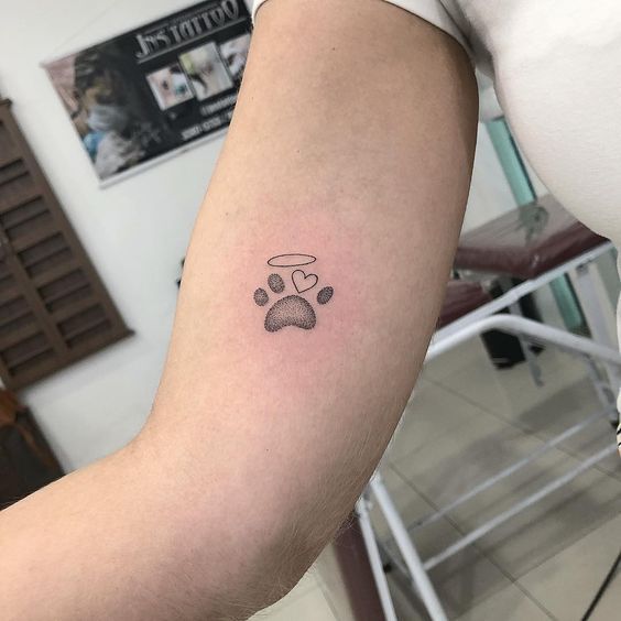 a person with a dog paw tattoo on their arm