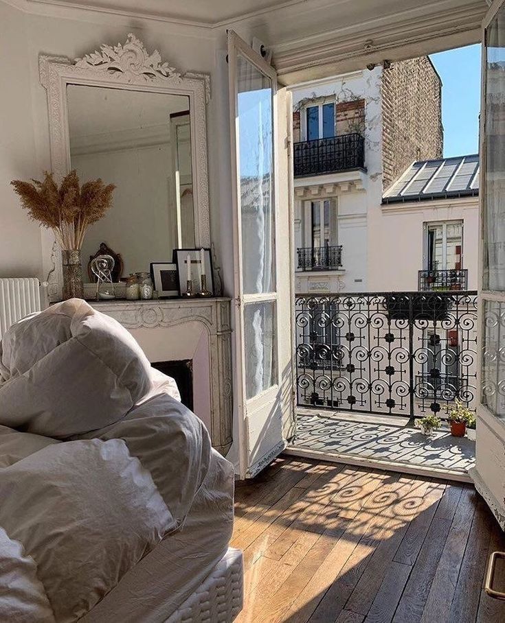 a bedroom with an open door leading to a balcony