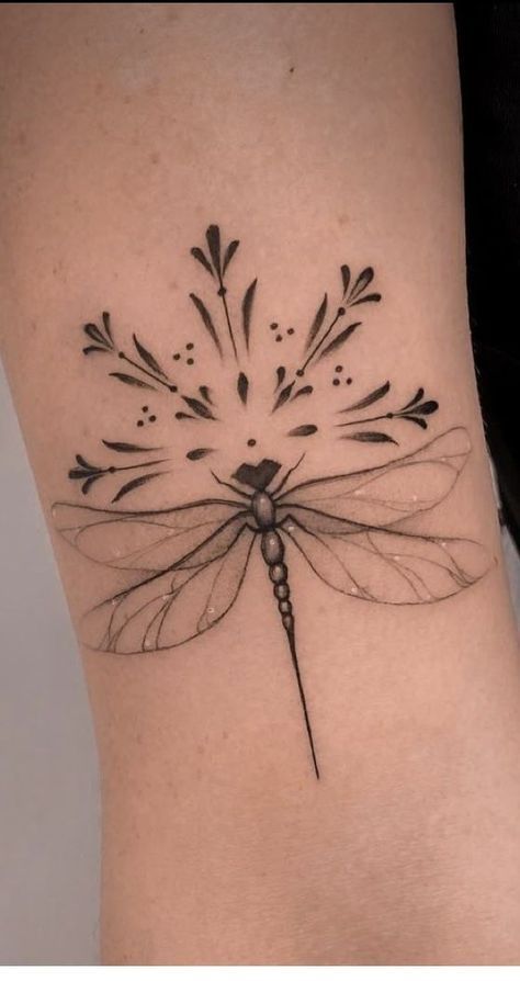 a black and white photo of a dragonfly tattoo