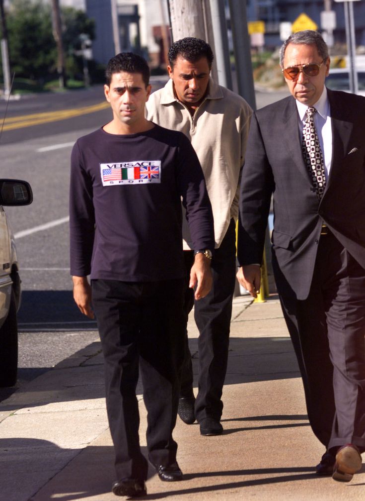 two men in suits walking down the street