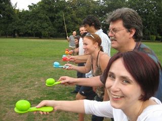 a group of people holding green frisbees in their hands