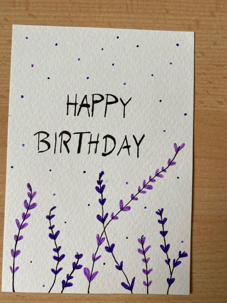 a happy birthday card with purple flowers on it