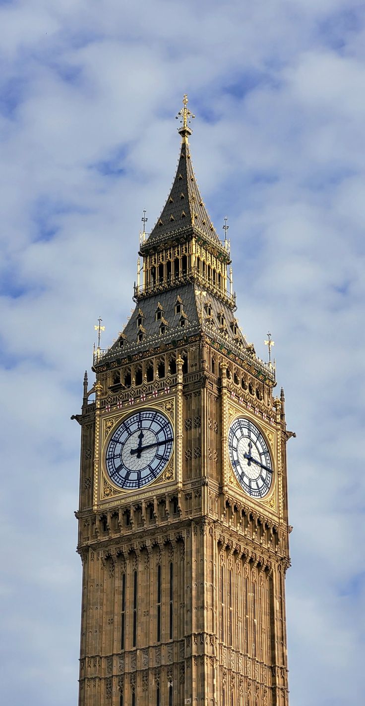 the big ben clock tower towering over the city of london on a partly cloudy day