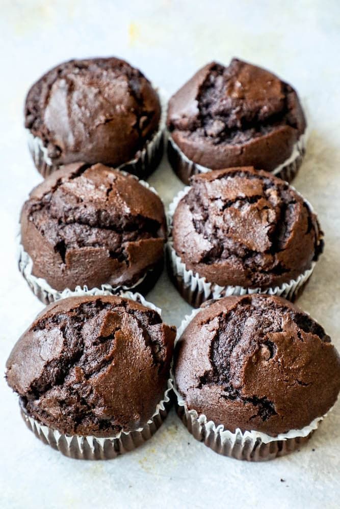 six chocolate muffins sitting on top of a table