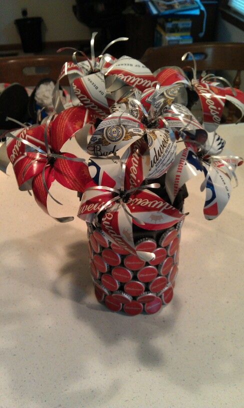 a cup filled with soda cans sitting on top of a table