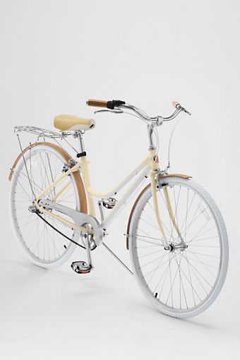 a white and tan bicycle is shown against a white background with no people around it