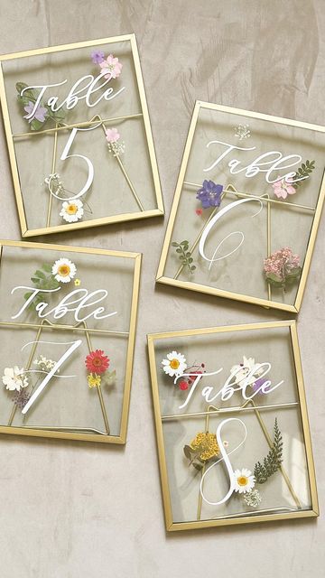 four glass frames with flowers in them and the letters i, j, f, v