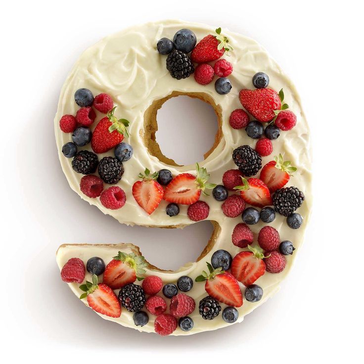 the letter s is made up of berries and strawberries on top of it's icing