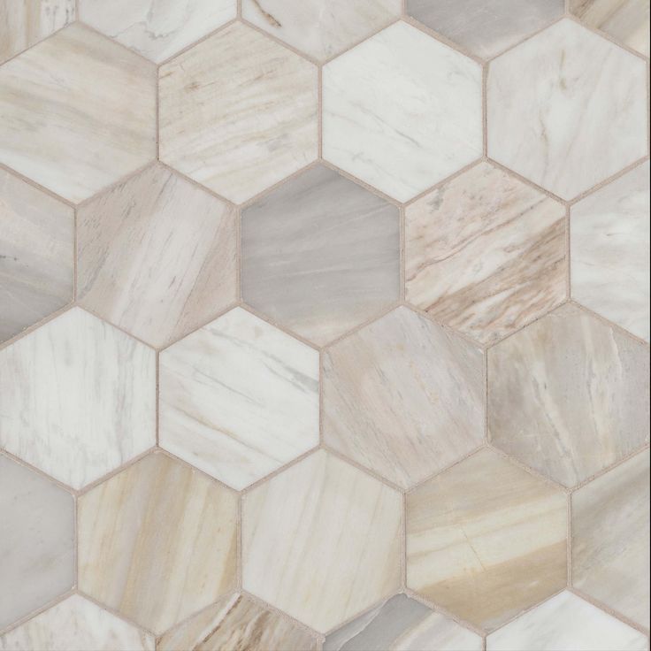 an image of a marble tile pattern that looks like hexagons in beige and white