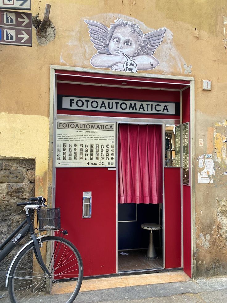 the entrance to an old fashion store with pink curtains