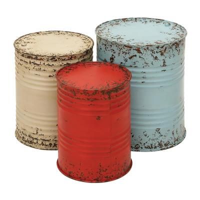 three tin canisters sitting next to each other on a white background, one red and one blue