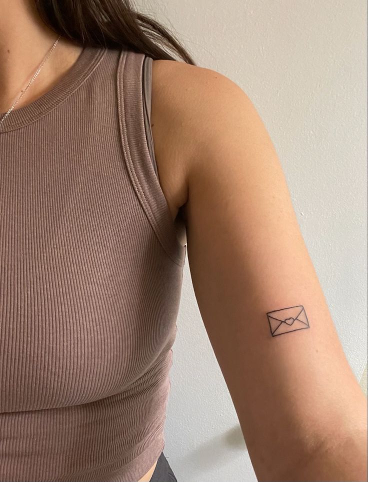 a woman with a small tattoo on her arm