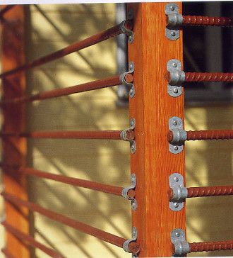 an orange wooden fence with metal bars on it