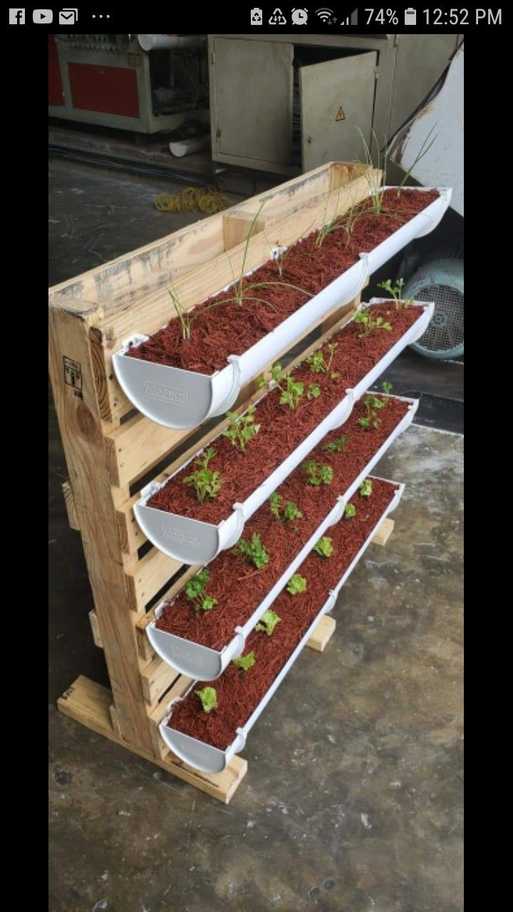 three tiered wooden planter with plants growing in it