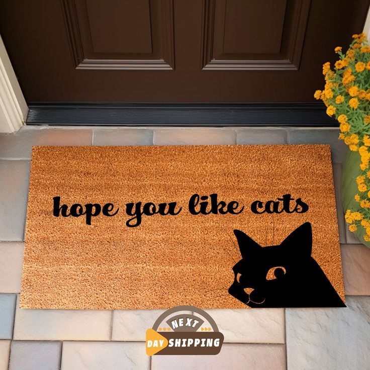 a door mat that says, hope you like cats