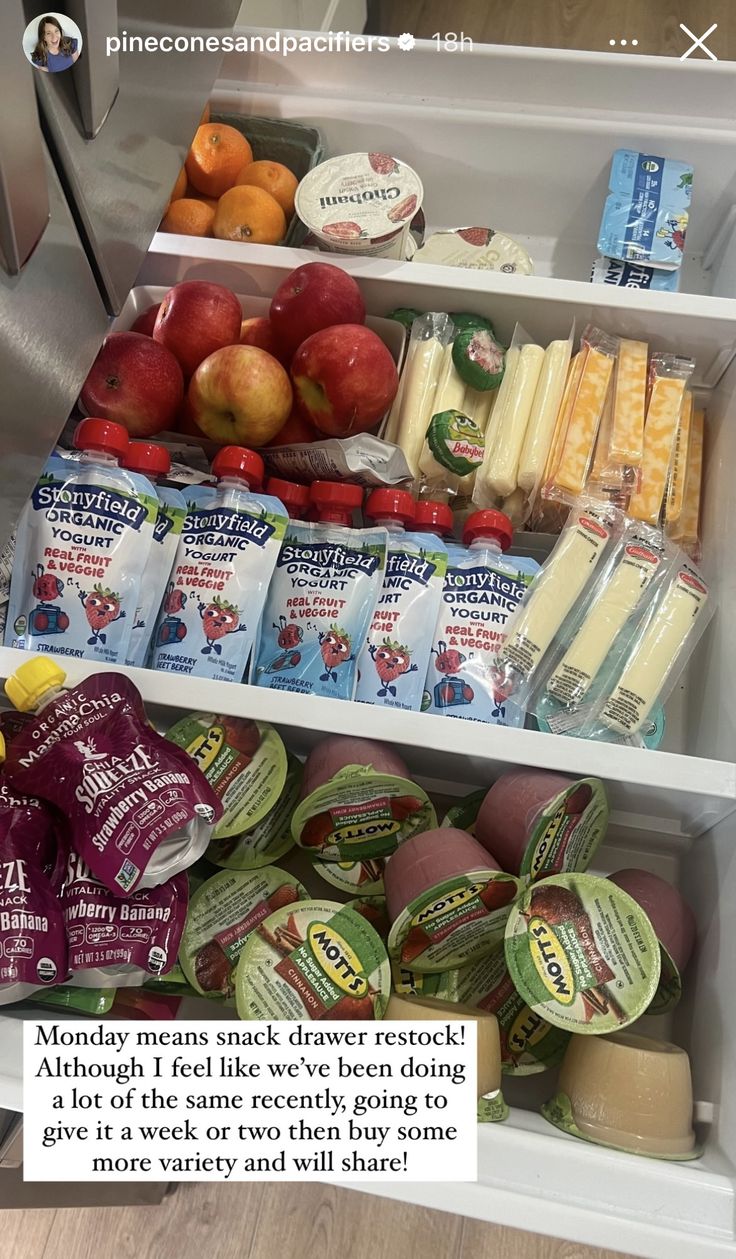 an open refrigerator filled with lots of different types of fruit and snacks on it's shelves