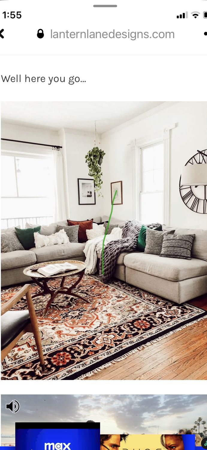 an image of a living room with couches and rugs