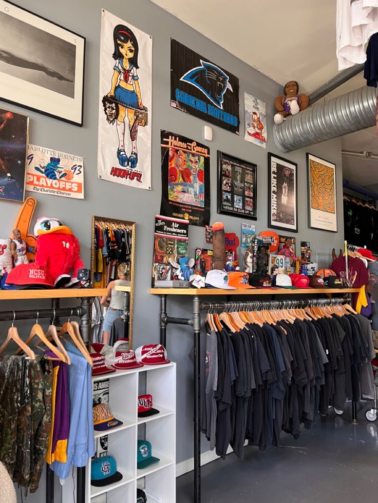 a room filled with lots of clothes and pictures on the wall above it's shelves