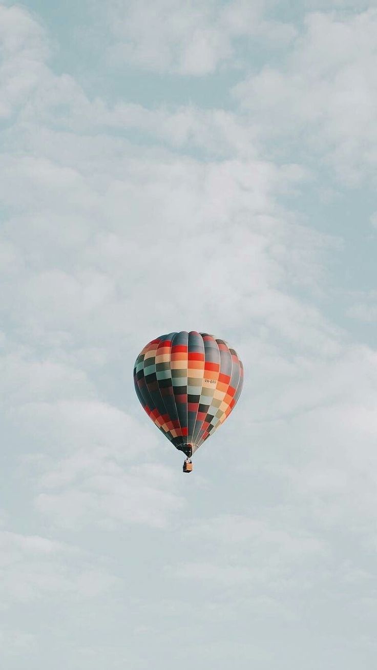 a colorful hot air balloon flying in the sky