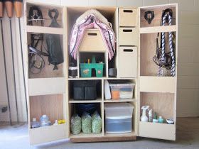 the inside of a wooden storage unit with many items in it's drawers and shelves