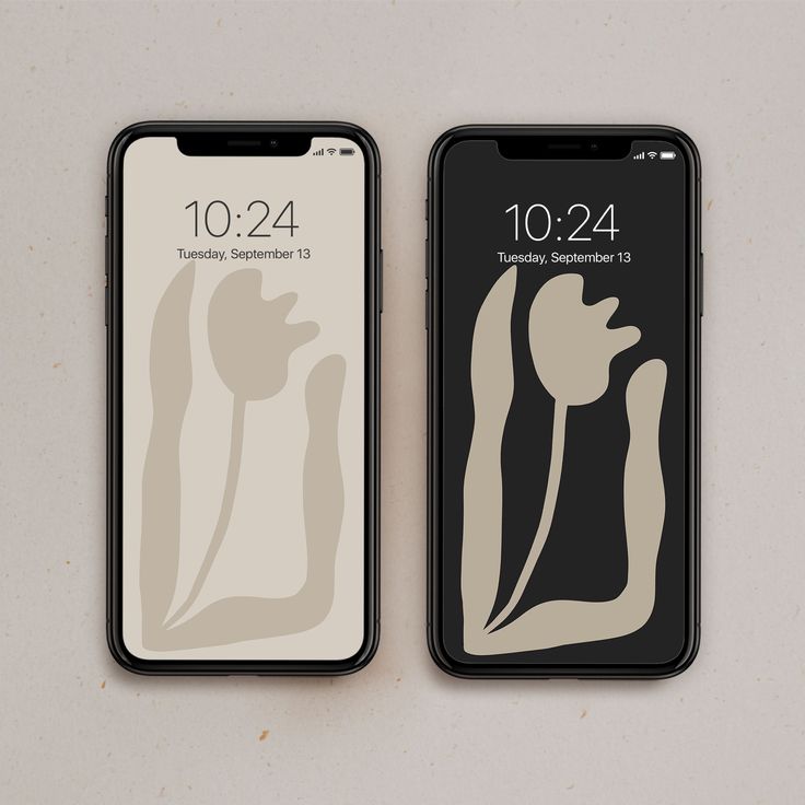 two iphones sitting next to each other on top of a white surface with black and gray designs