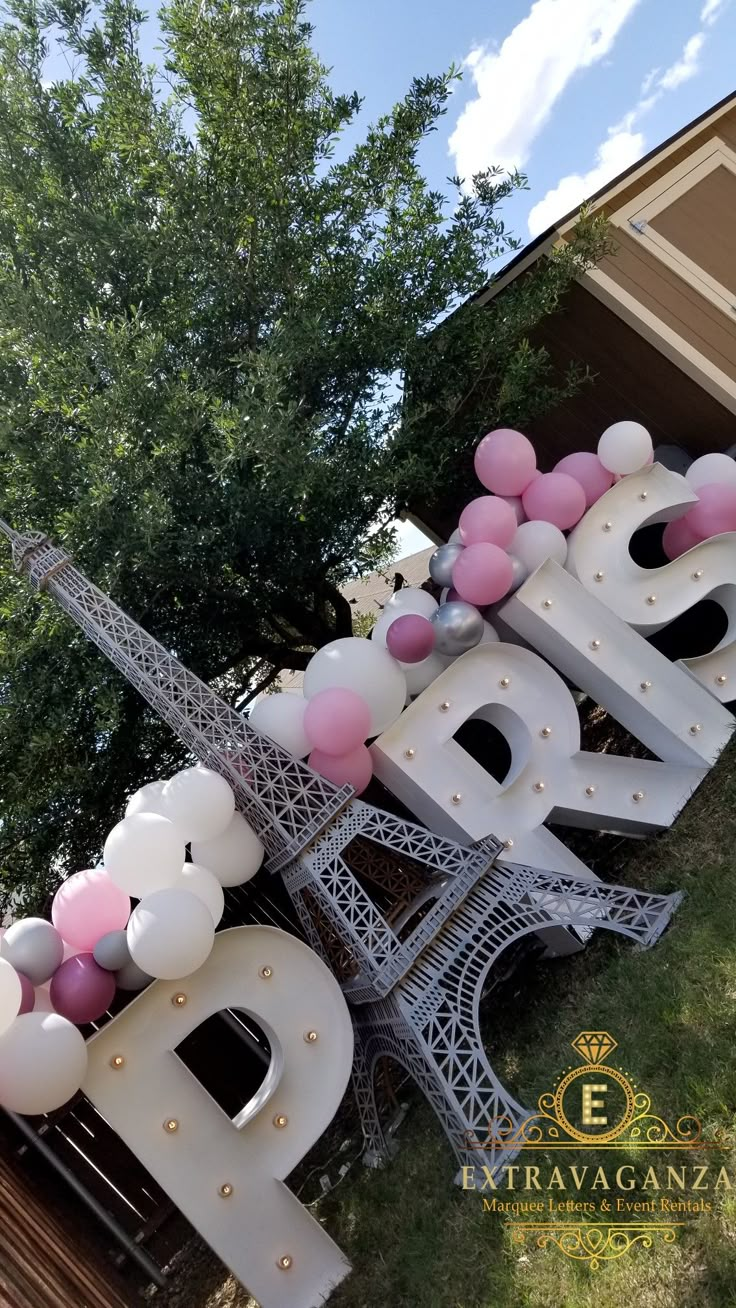 the eiffel tower is decorated with balloons