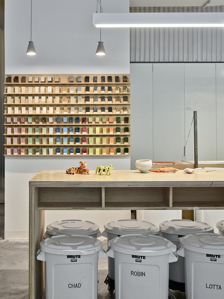 several buckets are lined up in front of a counter