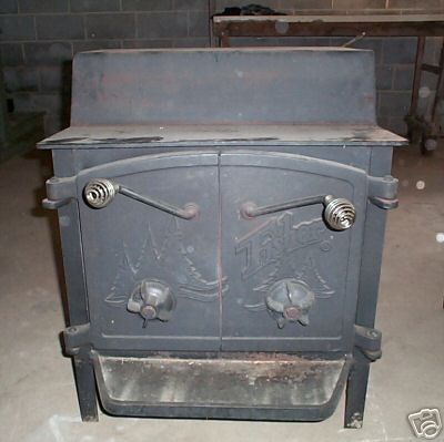 an old fashioned stove is sitting in a room